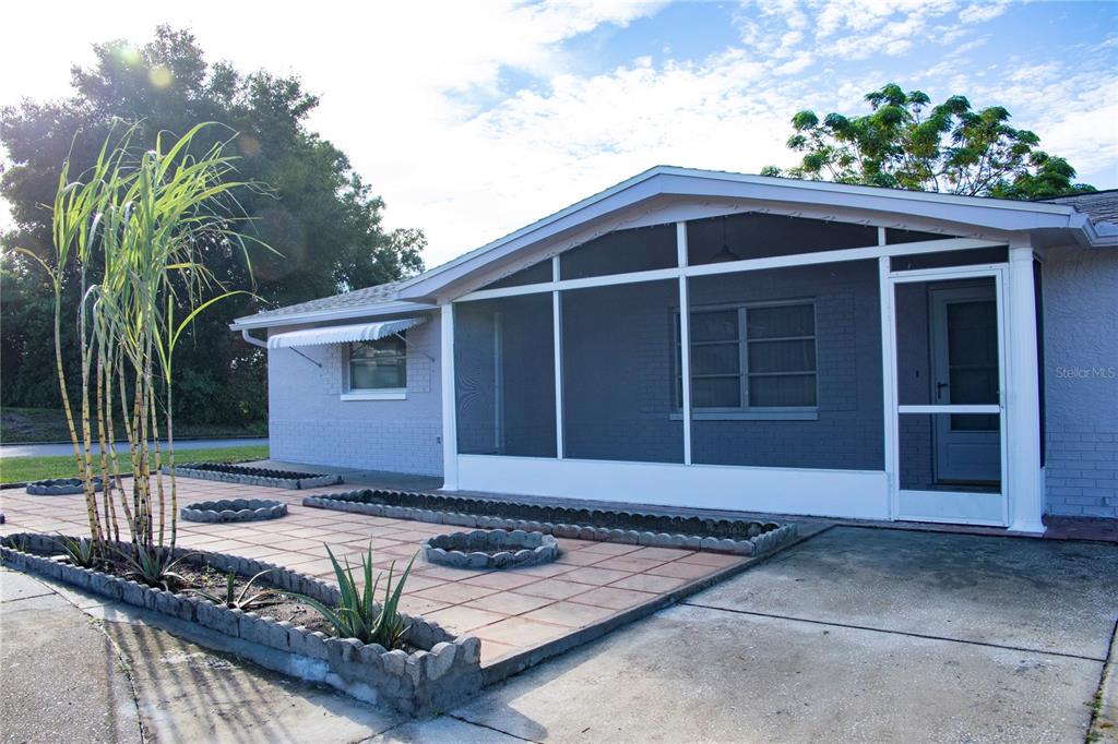 5116 Valimor Drive screened front porch and built in planters...