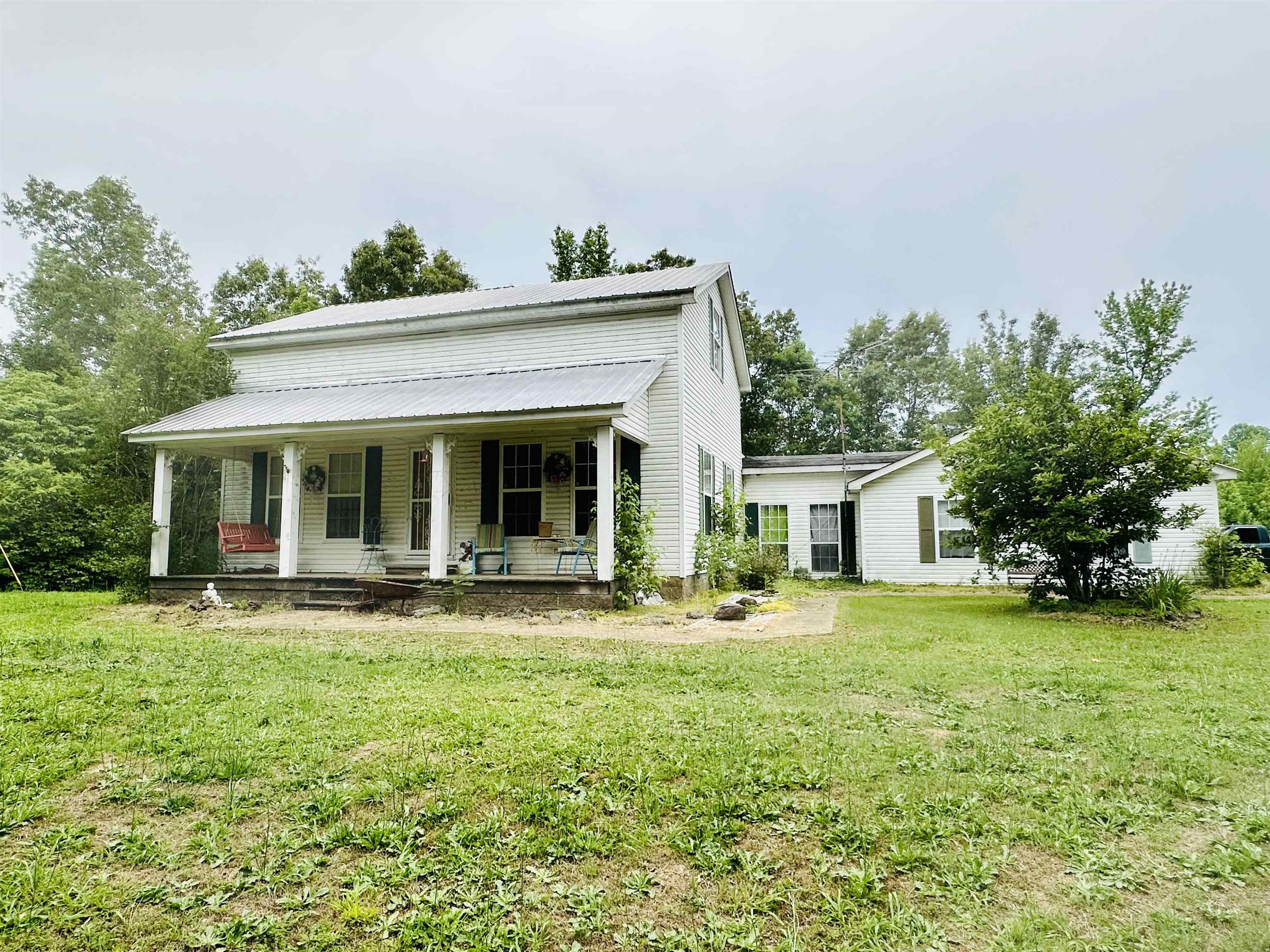 front view of a house with a yard and trees