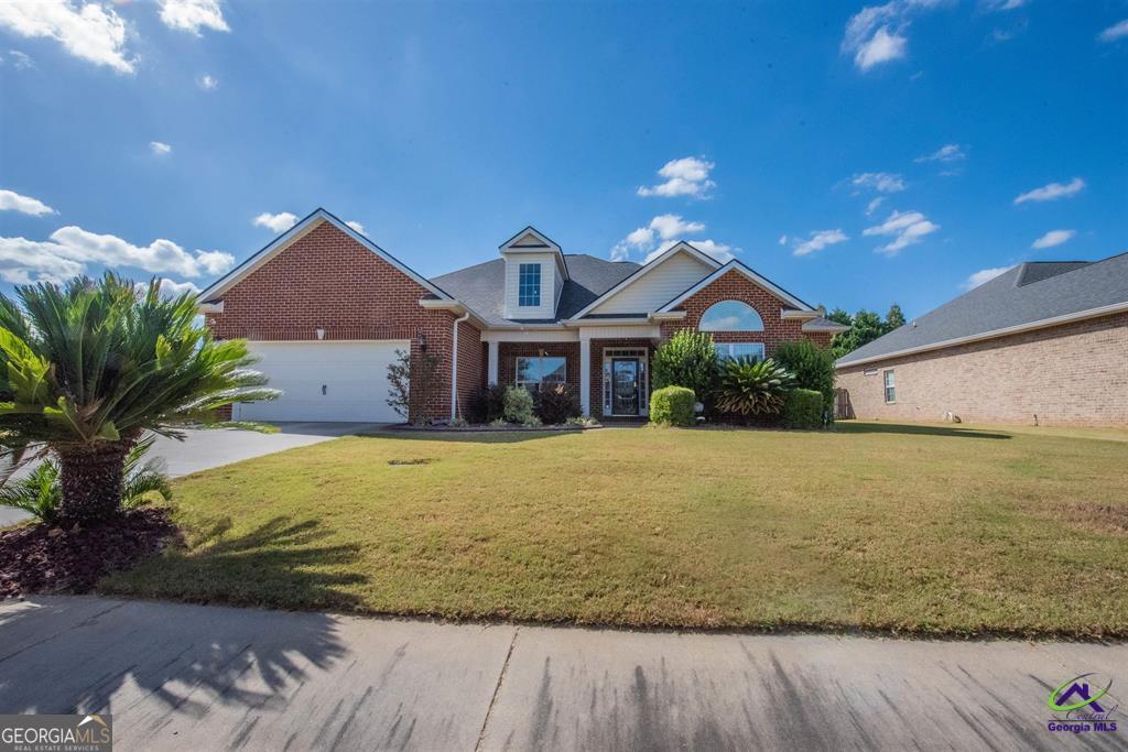 a front view of a house with a yard