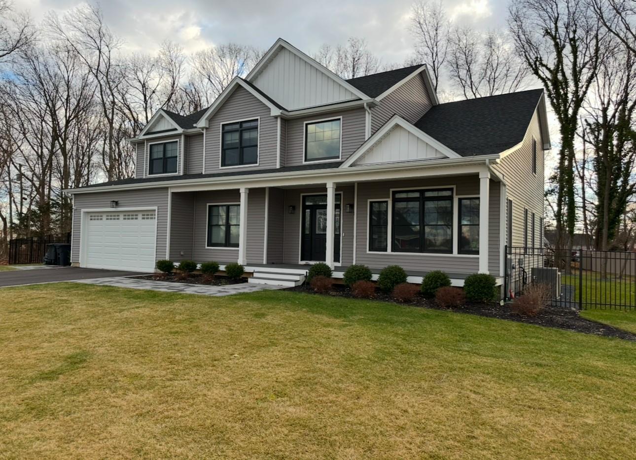 View of front of property with a front lawn and a garage