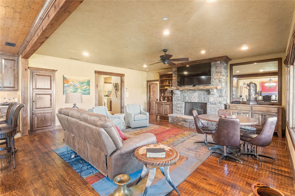 a living room with fireplace furniture and a large window