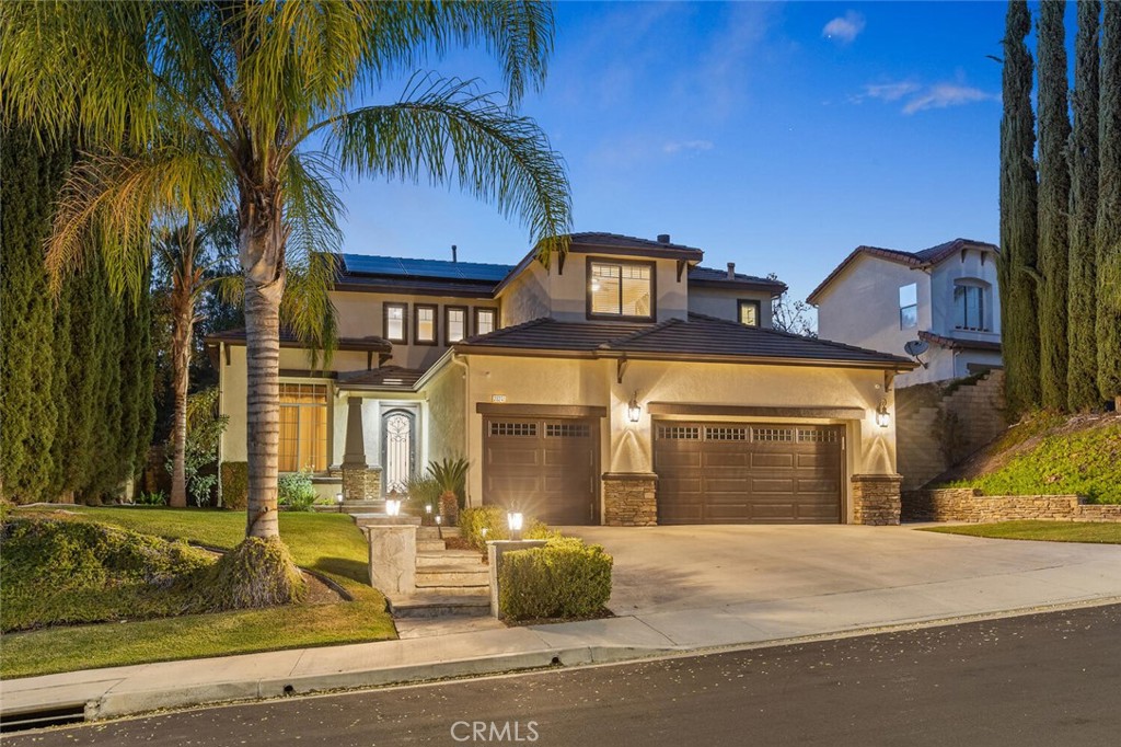 a front view of a house with parking area