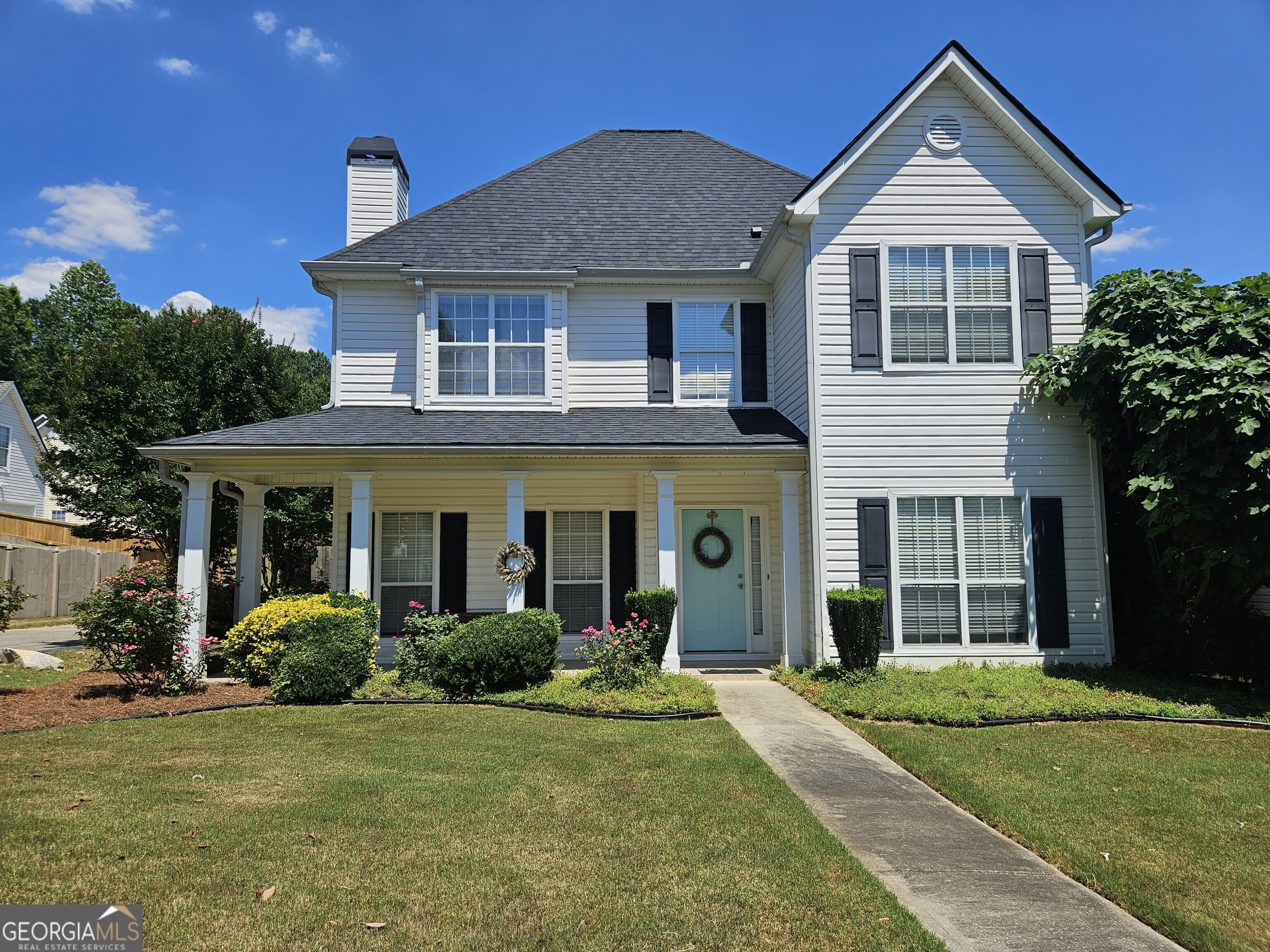 a front view of a house with garden