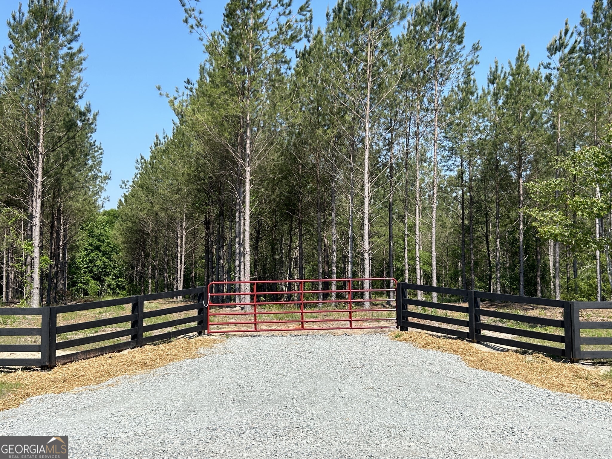 a view of outdoor space with wooden fence