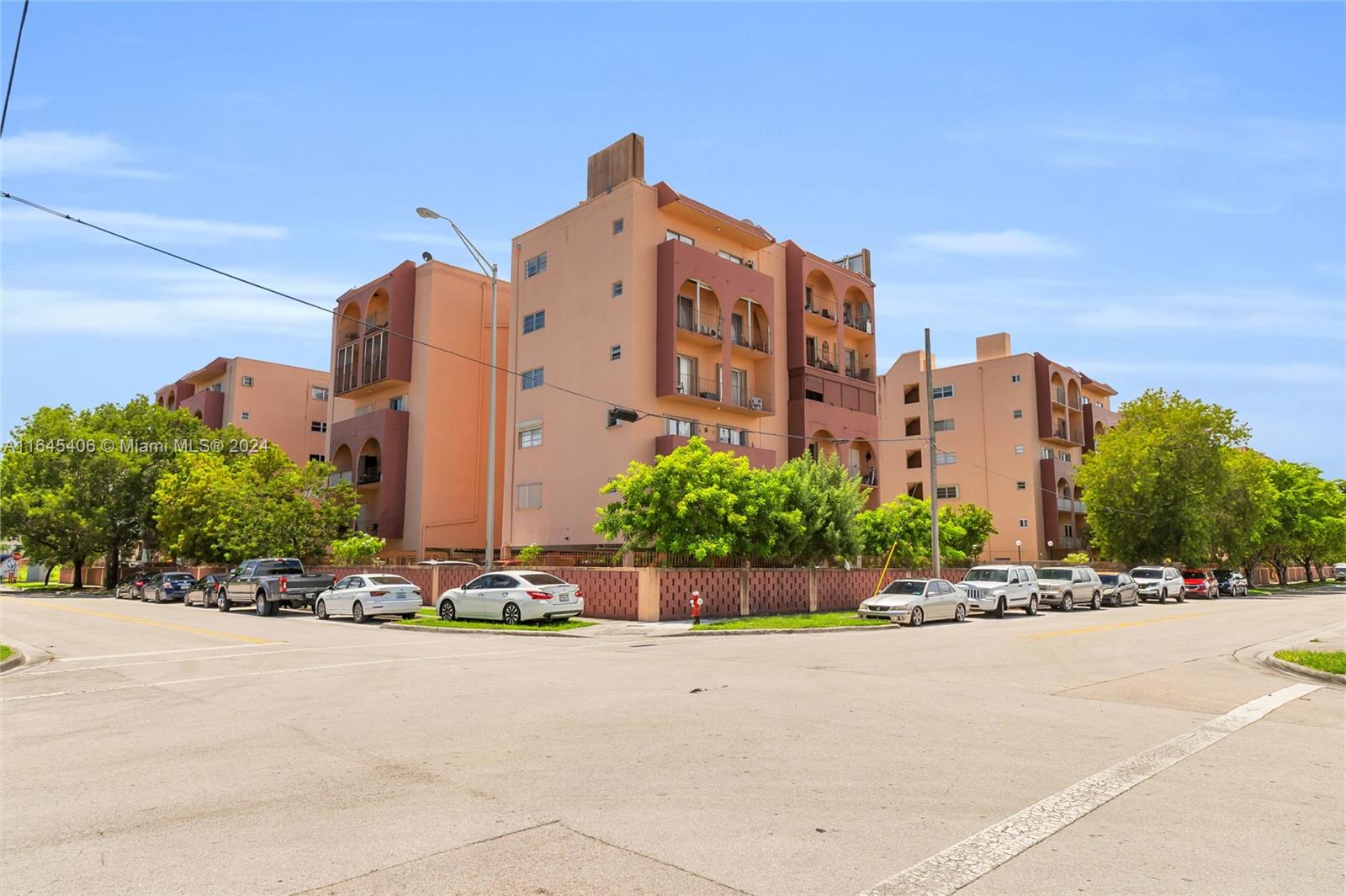 a front view of a building with a garden