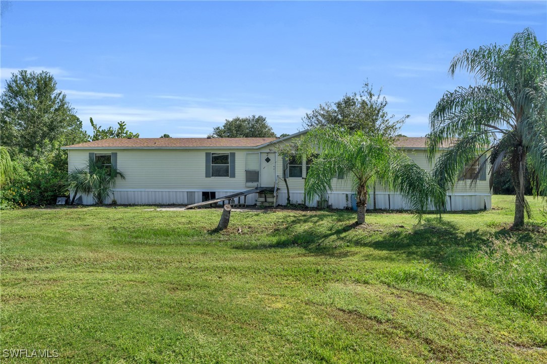 a view of a house with a backyard