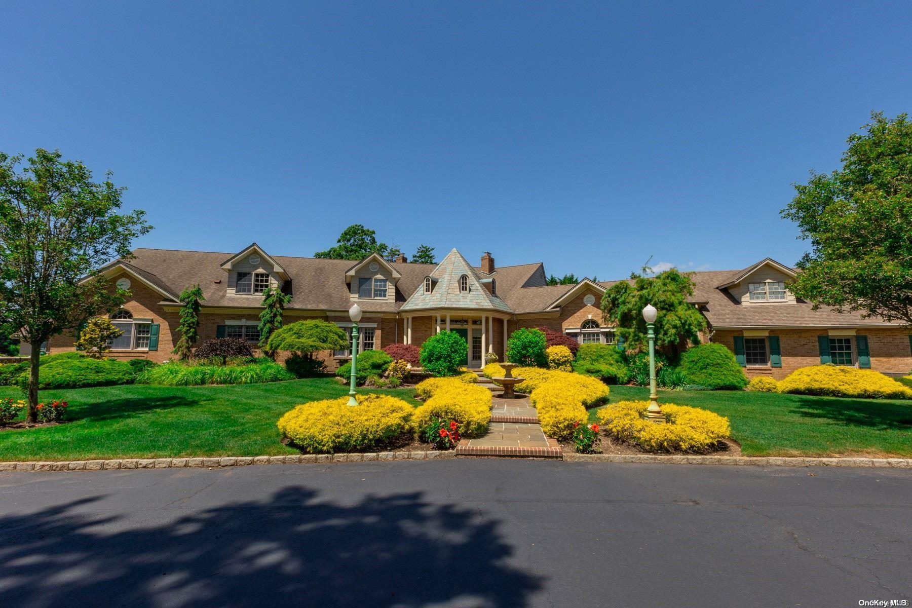 a front view of a house with garden and porch