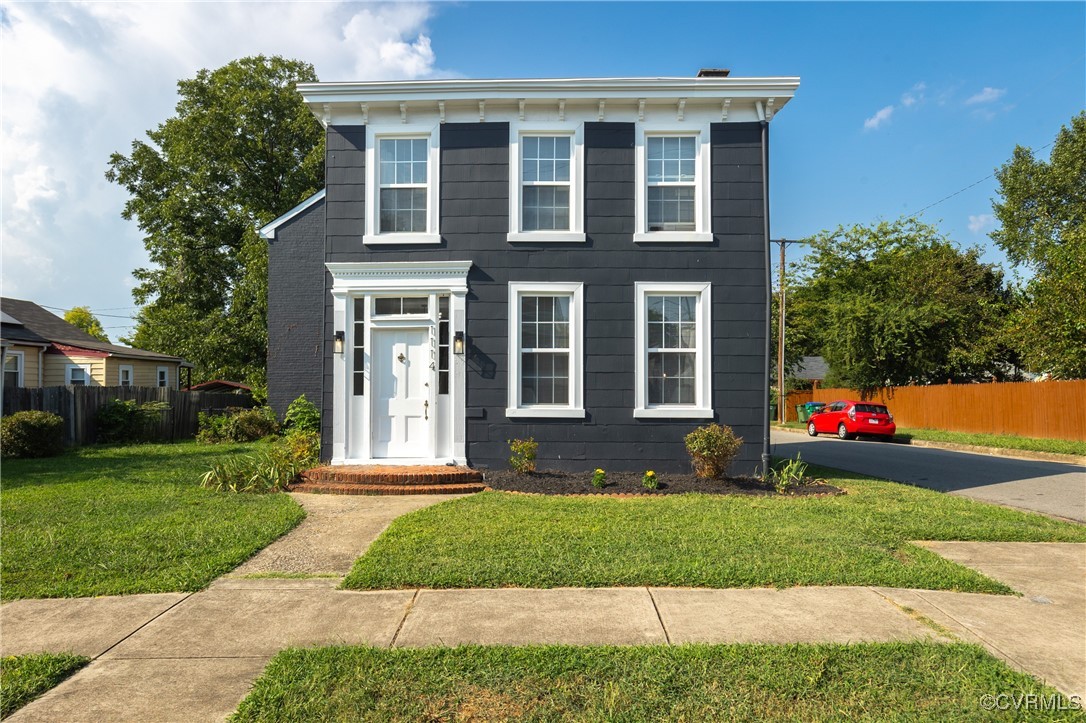 a front view of house with yard and green space