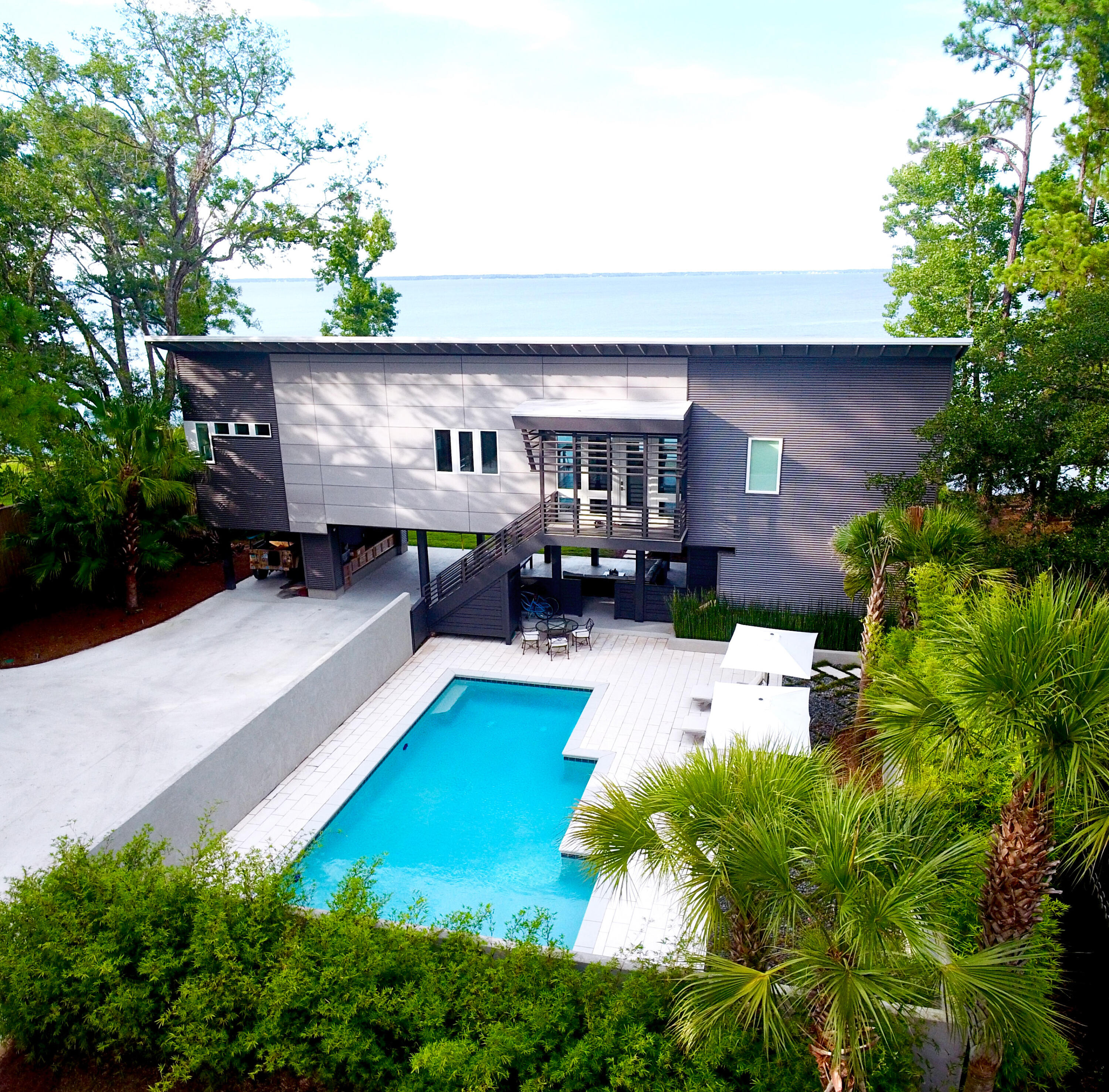 an aerial view of a house with swimming pool garden view patio and fire pit