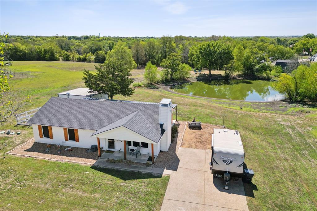 an aerial view of a house with swimming pool garden and patio