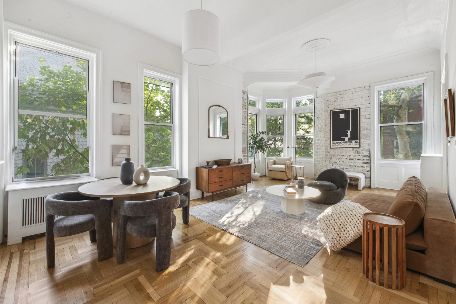 a living room with fireplace furniture and a large window