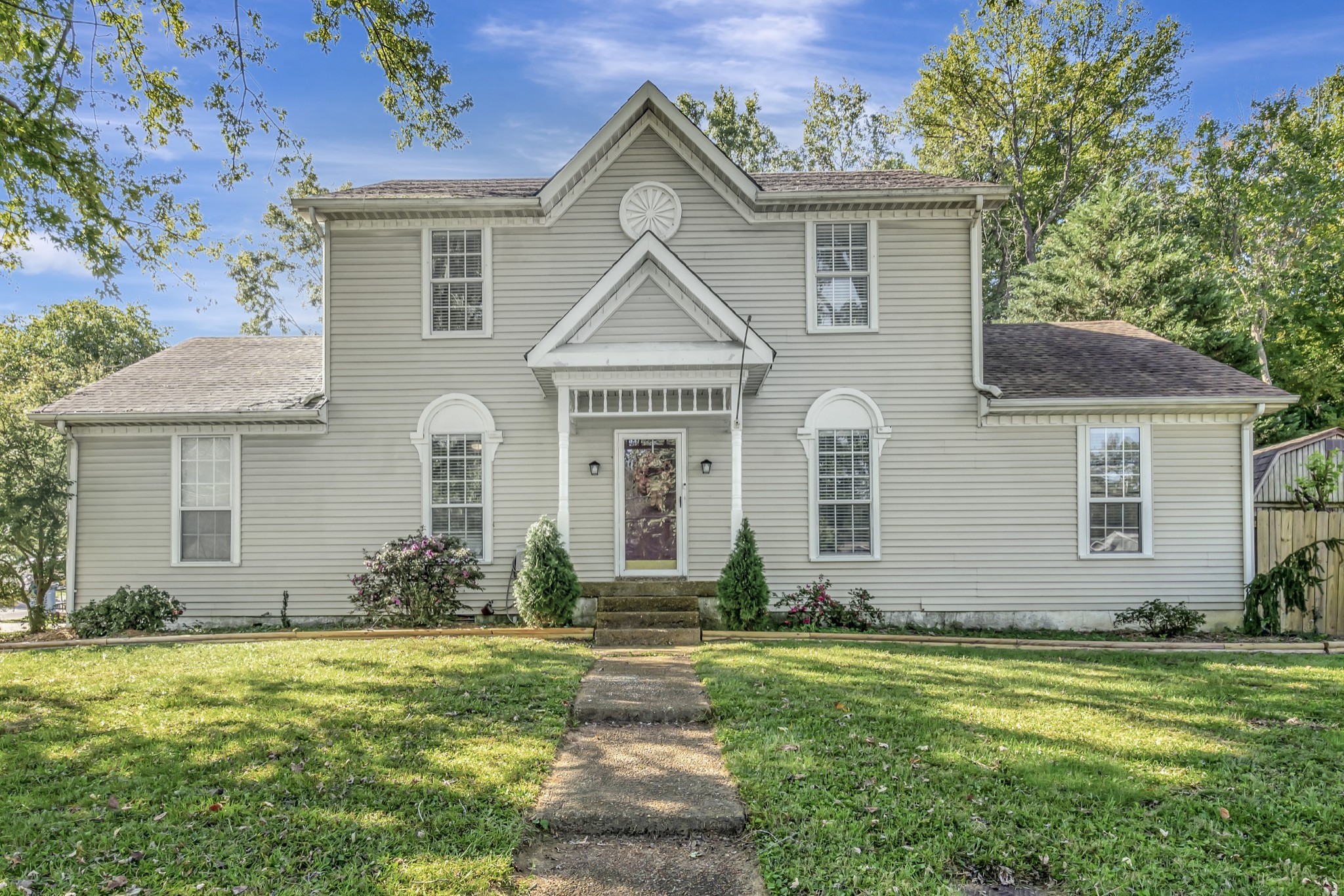 a front view of a house with garden