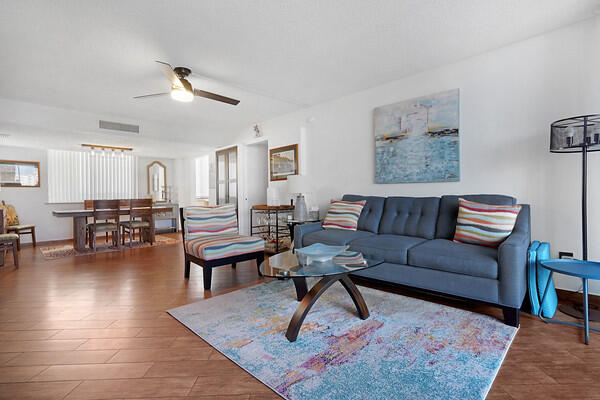 a living room with furniture a rug and a table