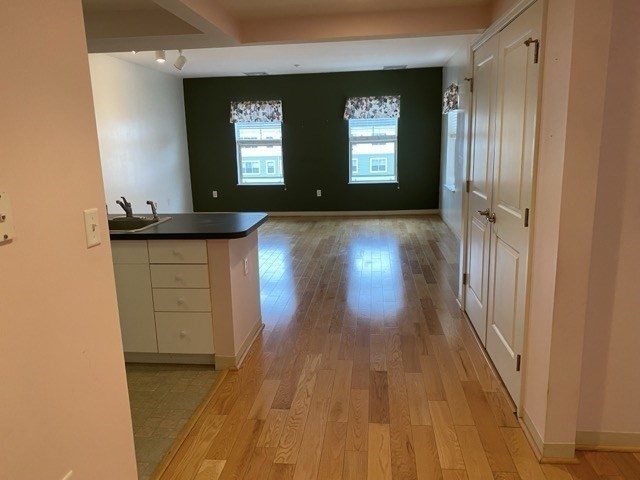 a view of a room with wooden floor and windows