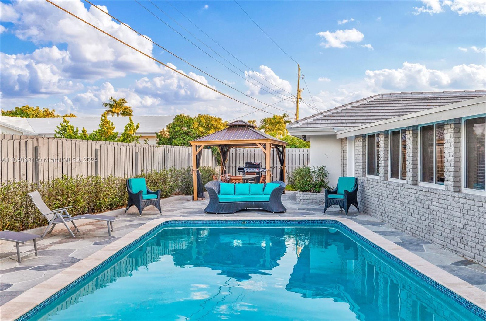 a house view with swimming pool and outdoor seating