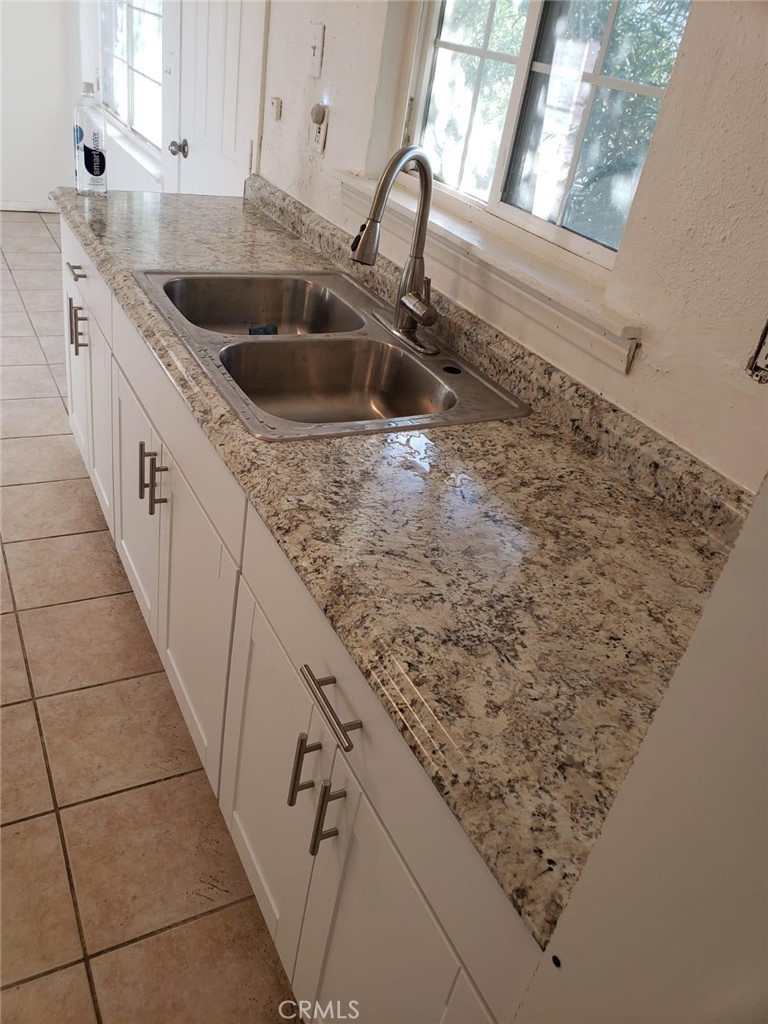 a kitchen with a sink and cabinets