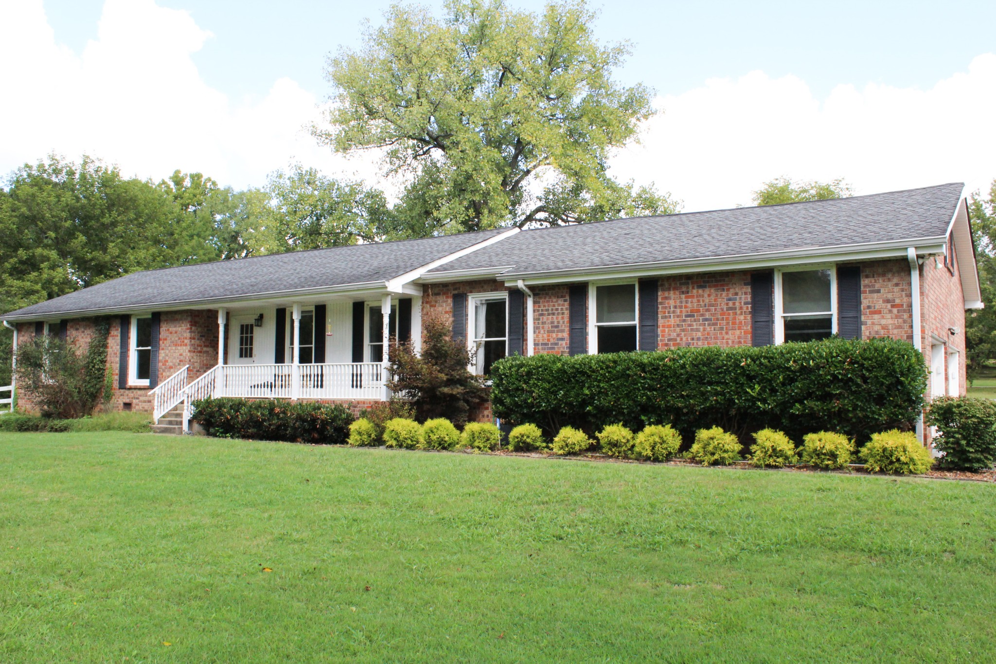 a front view of a house with a garden