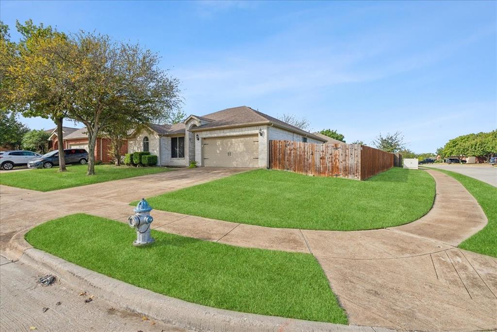 a front view of a house with a yard and trees