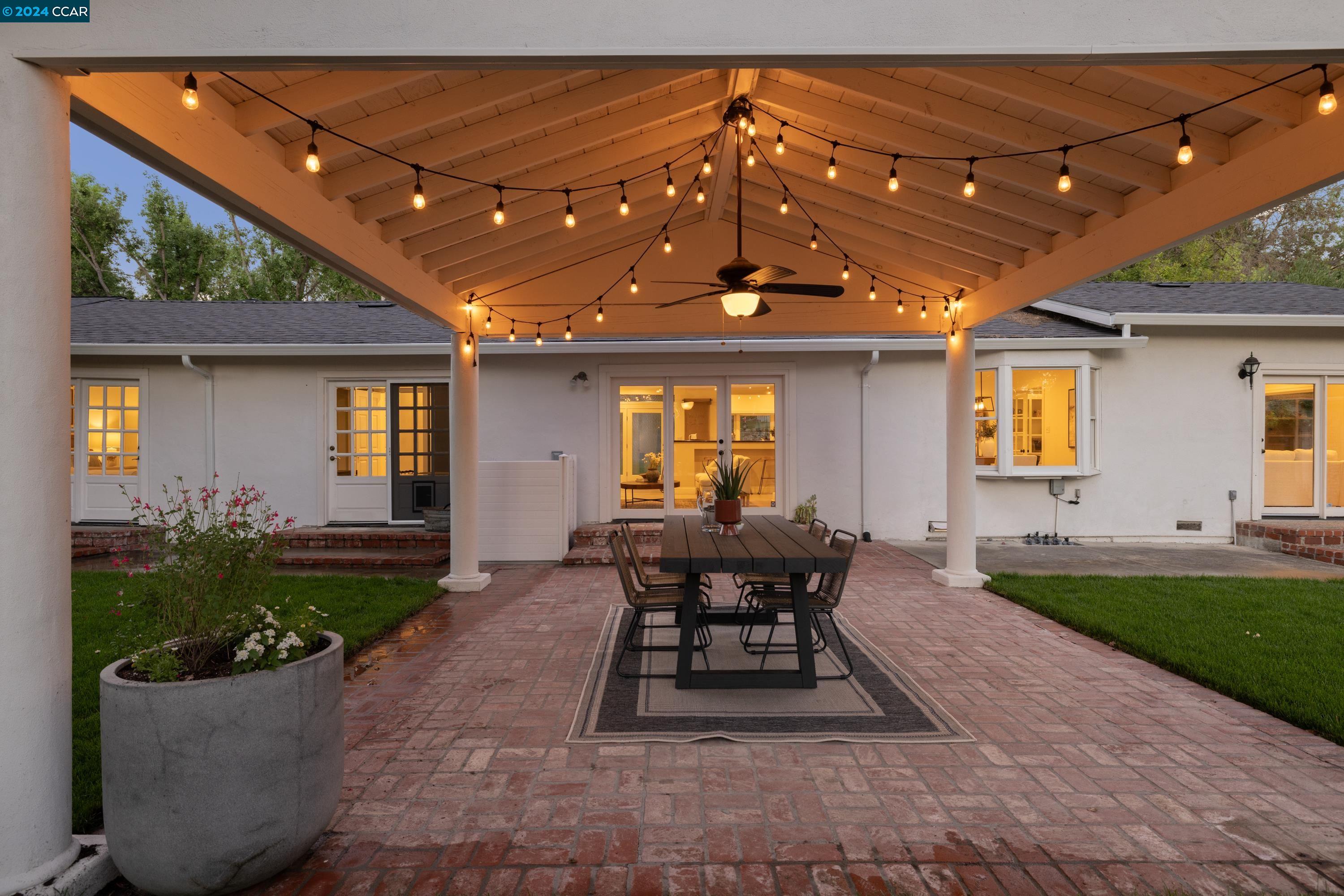 a view of a house with backyard and sitting area