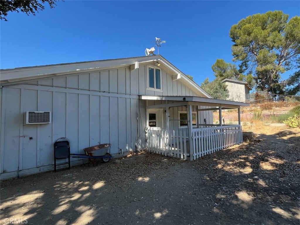 a view of a house with a small yard and wooden fence