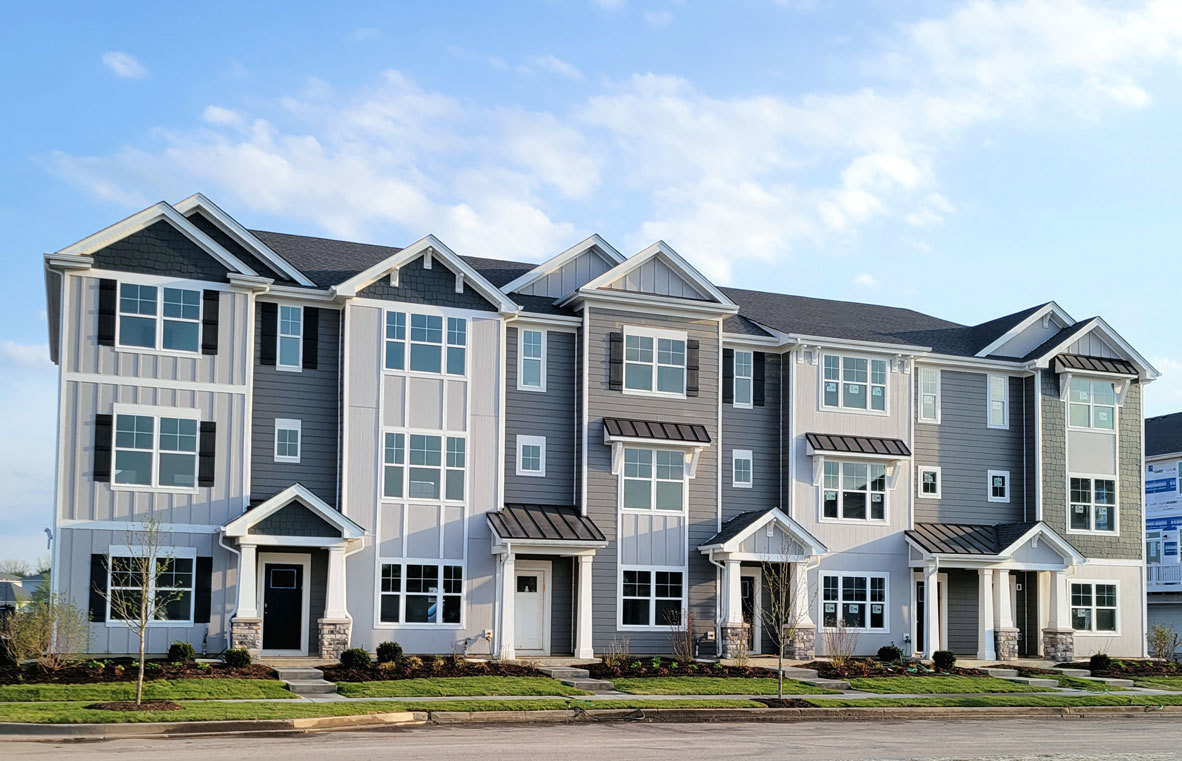 a front view of residential houses with yard