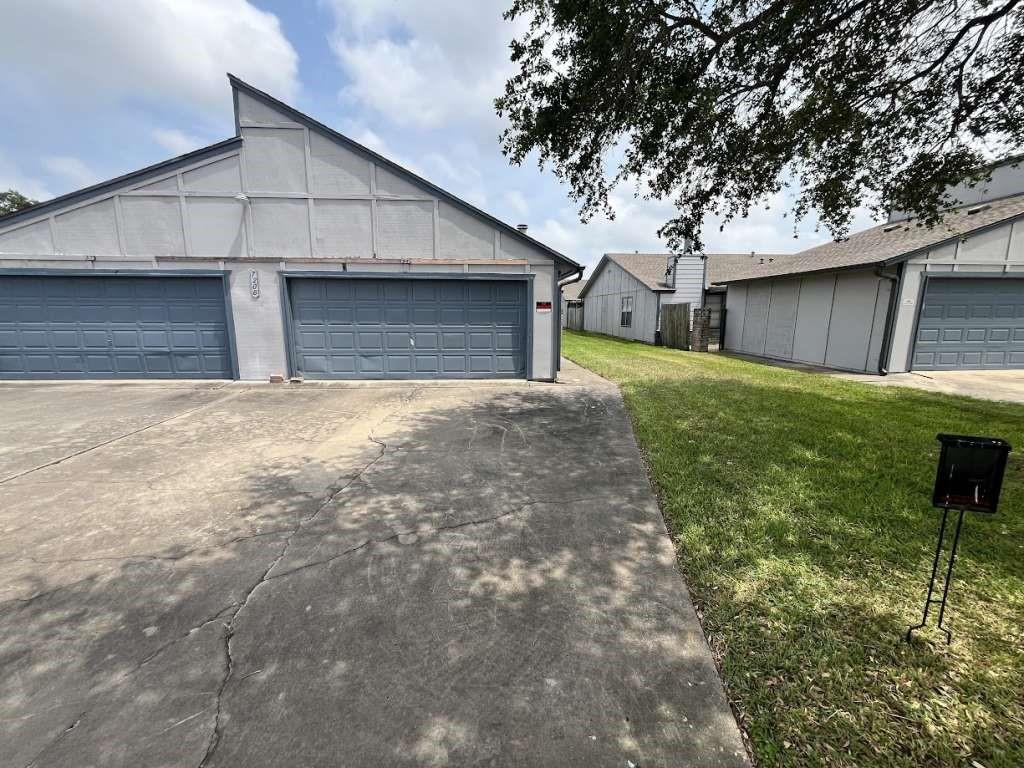 a view of a house with a yard and garage