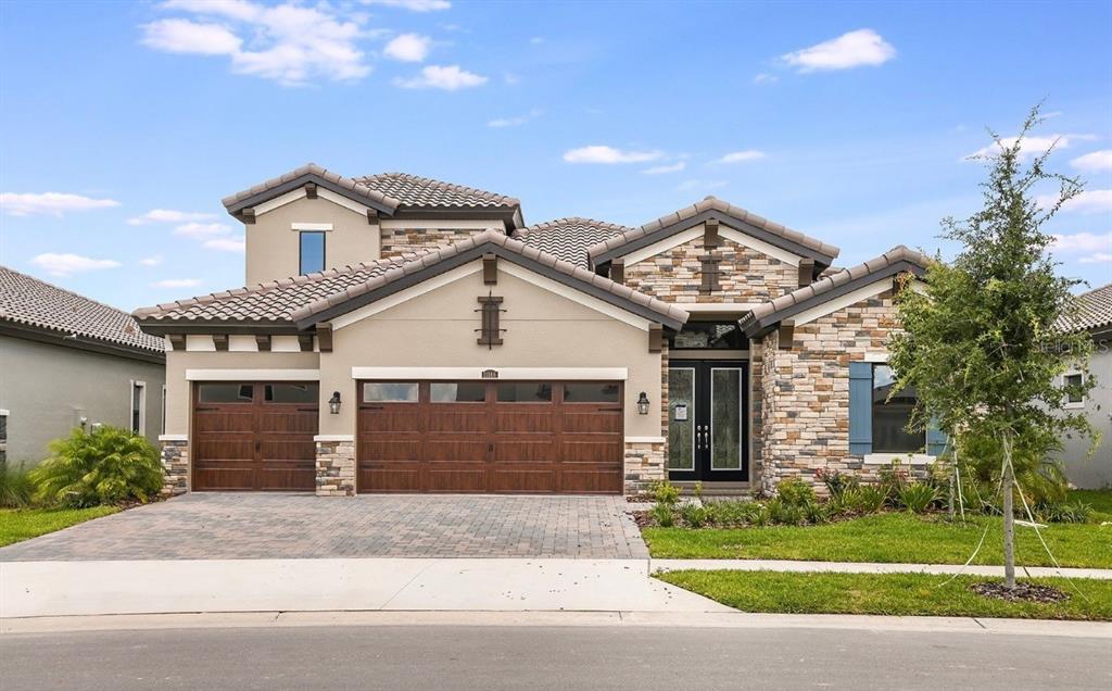 a view of a house with a yard and garage