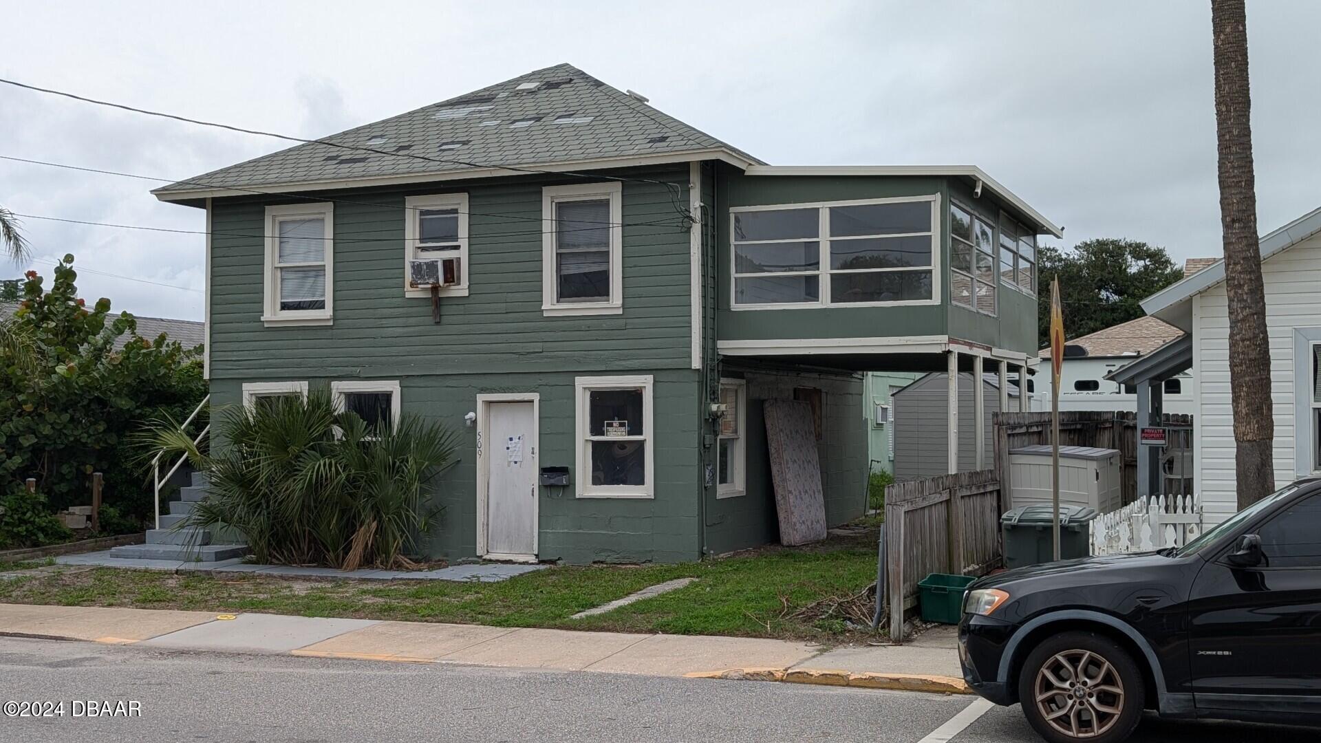 a front view of a house with a garden