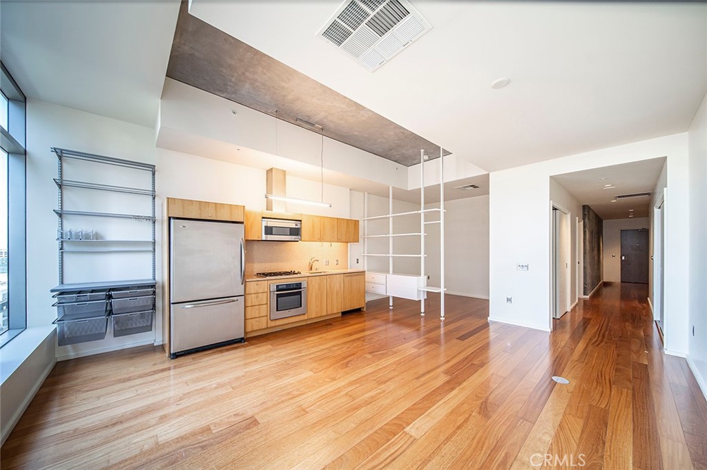 a view of a kitchen with wooden floor and a kitchen