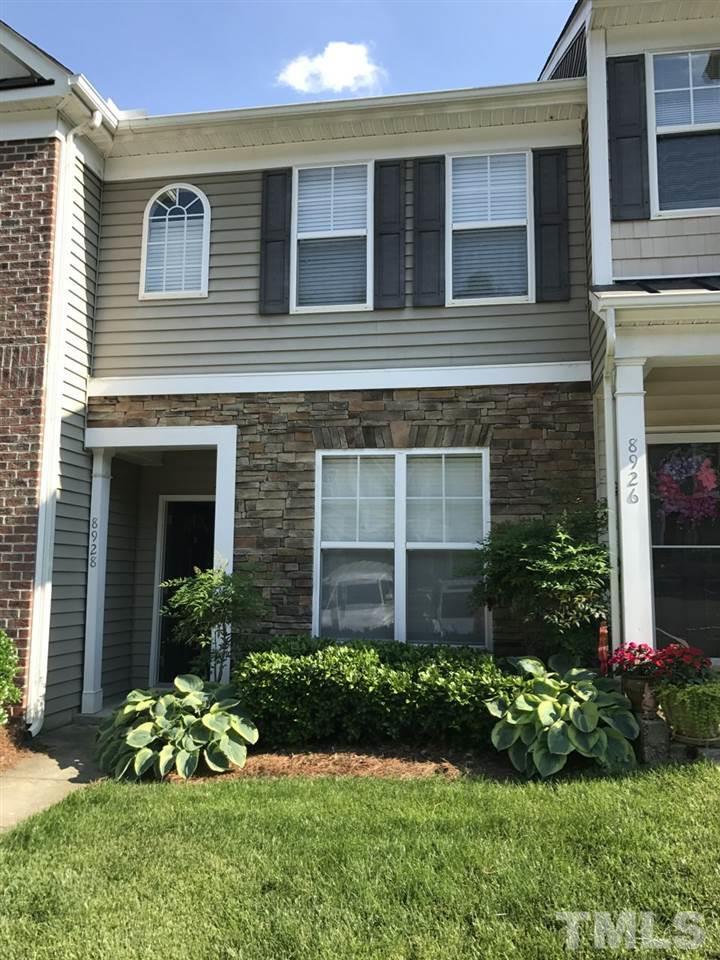 a house with a flower garden in front of it