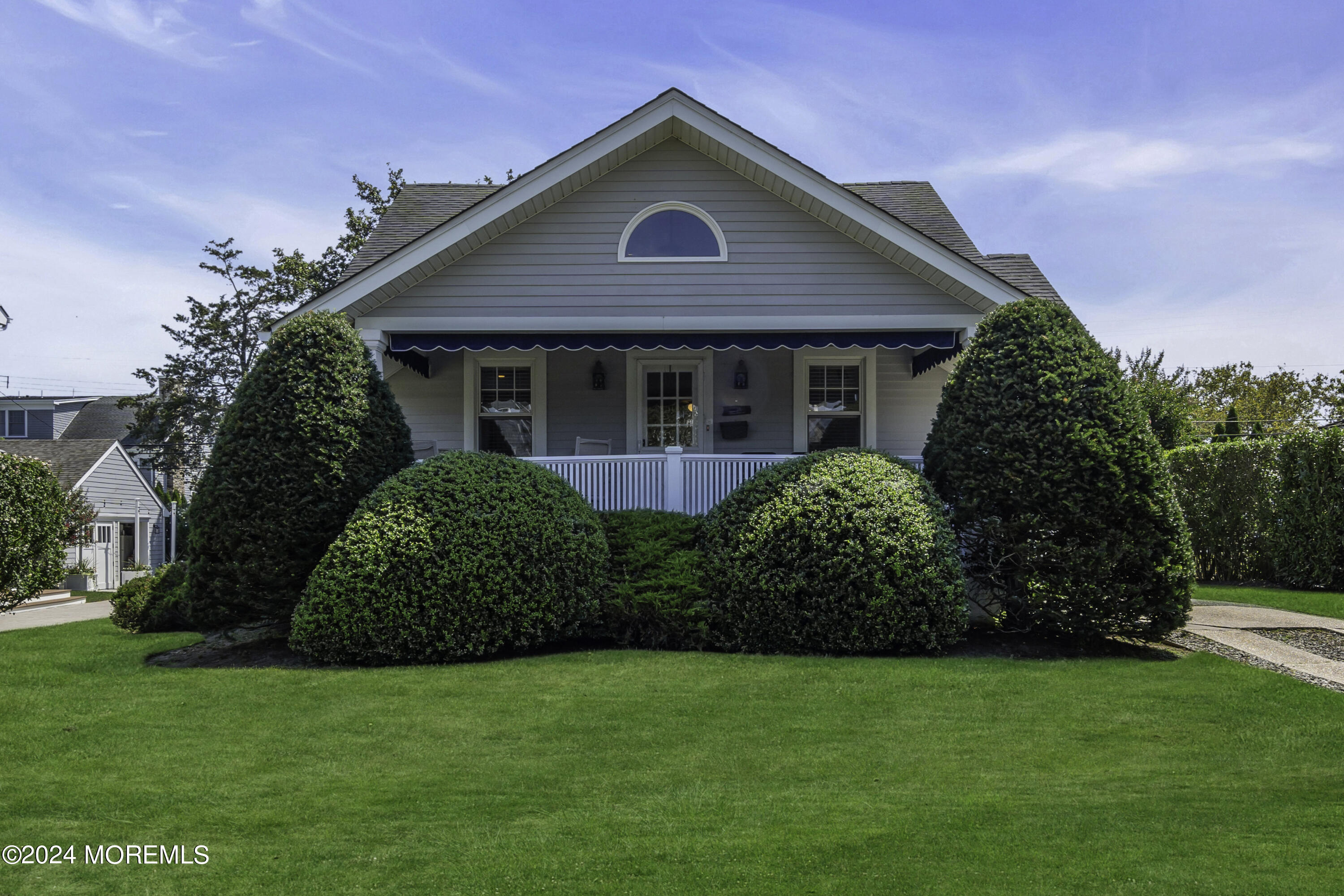 a front view of a house with a garden