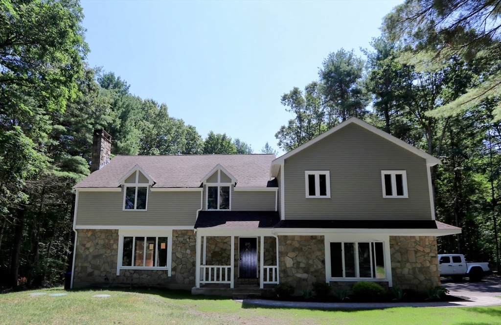 a view of house with yard