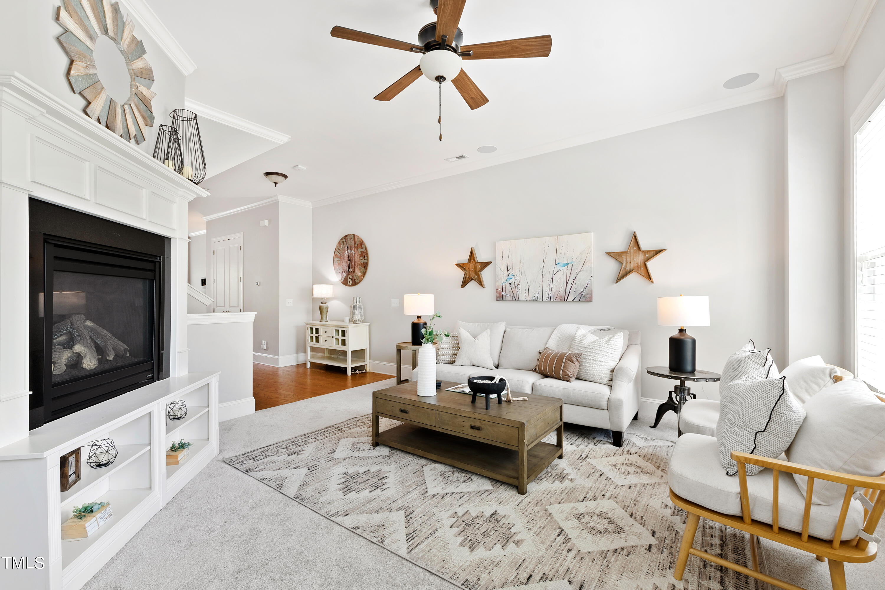 a living room with furniture a flat screen tv and a fireplace