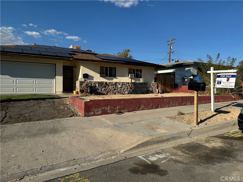 a view of a house with a yard and lawn chairs