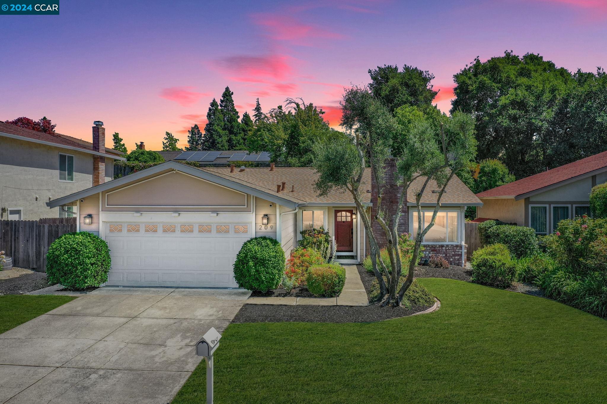 a front view of a house with a yard