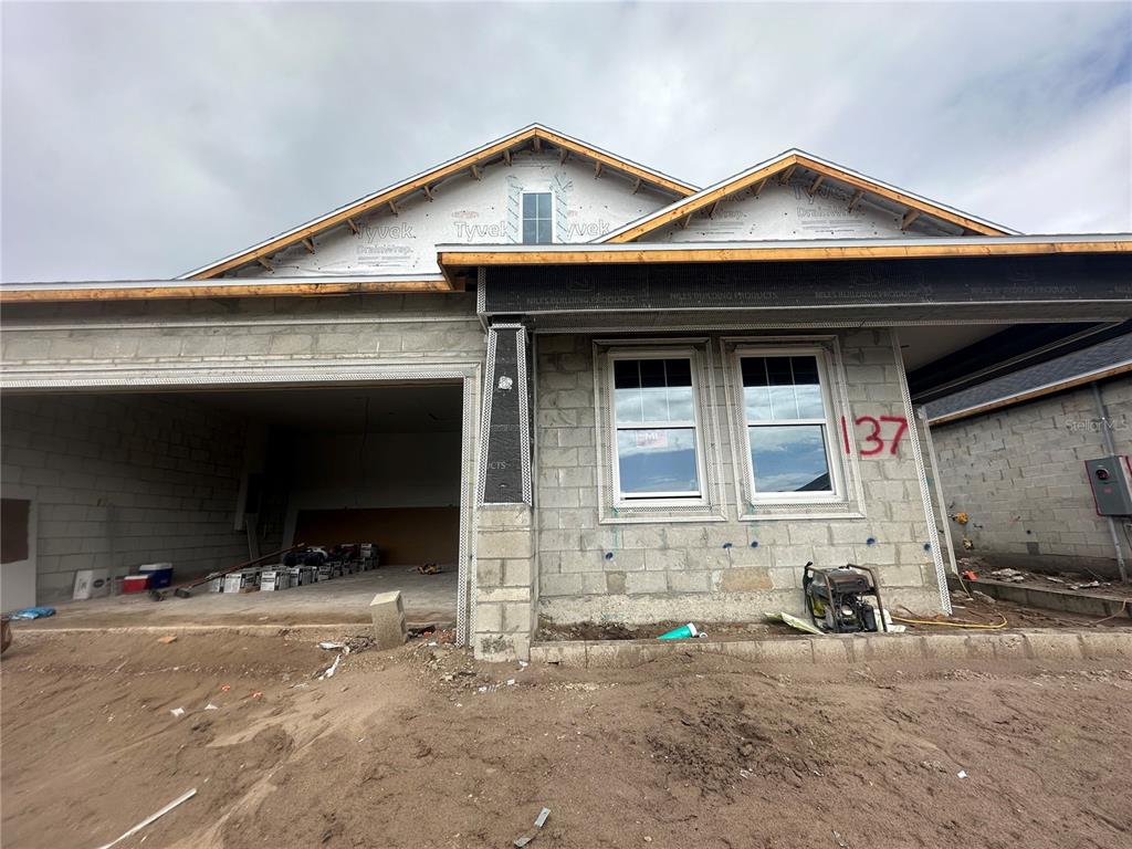 a front view of a house with cars