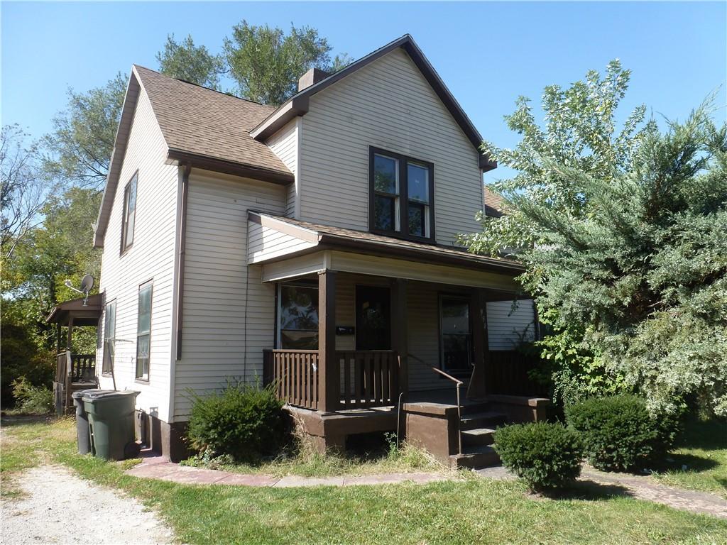 a view of house with backyard and garden