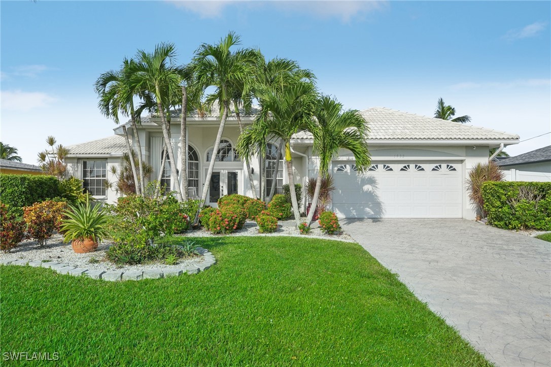 a front view of a house with a garden and plants