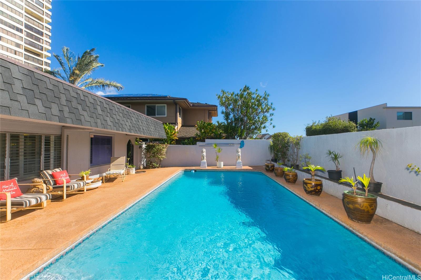 a swimming pool with outdoor seating