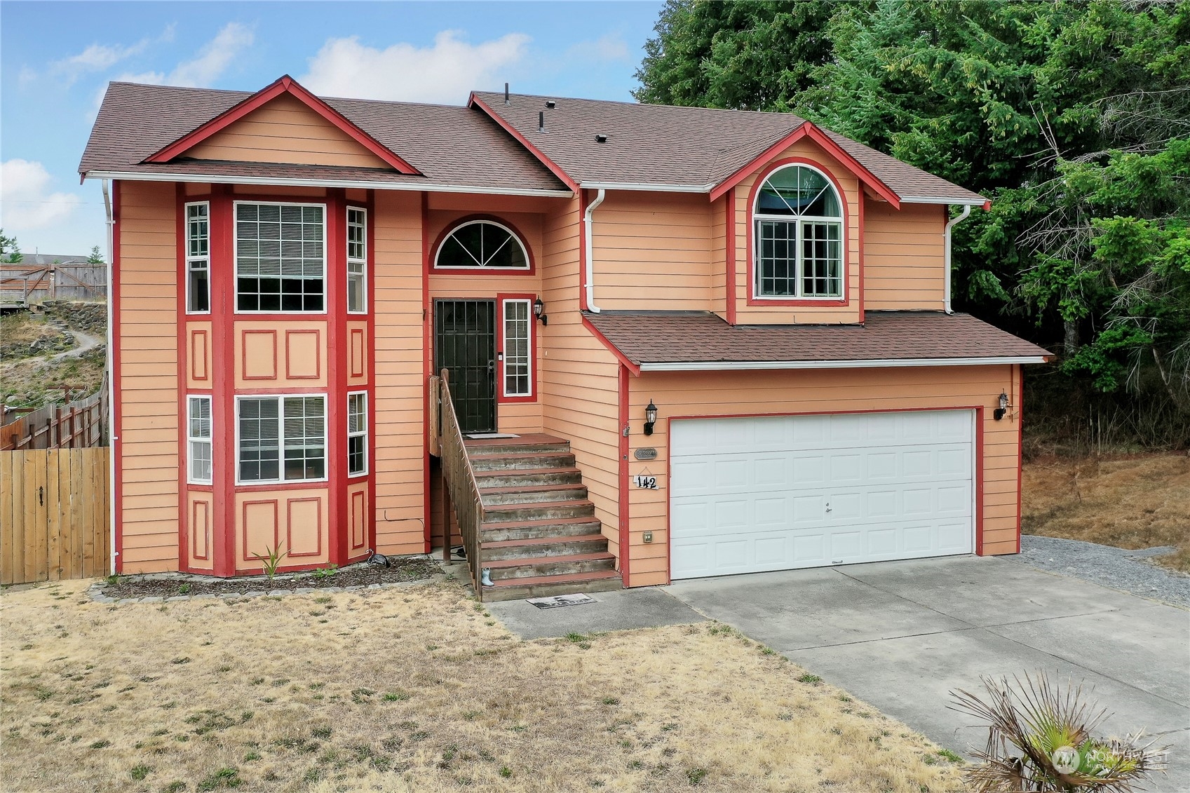 a front view of a house with a yard and garage