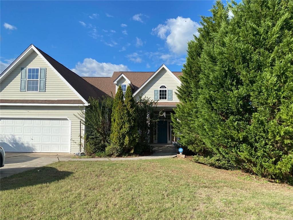 a front view of a house with a yard and garage