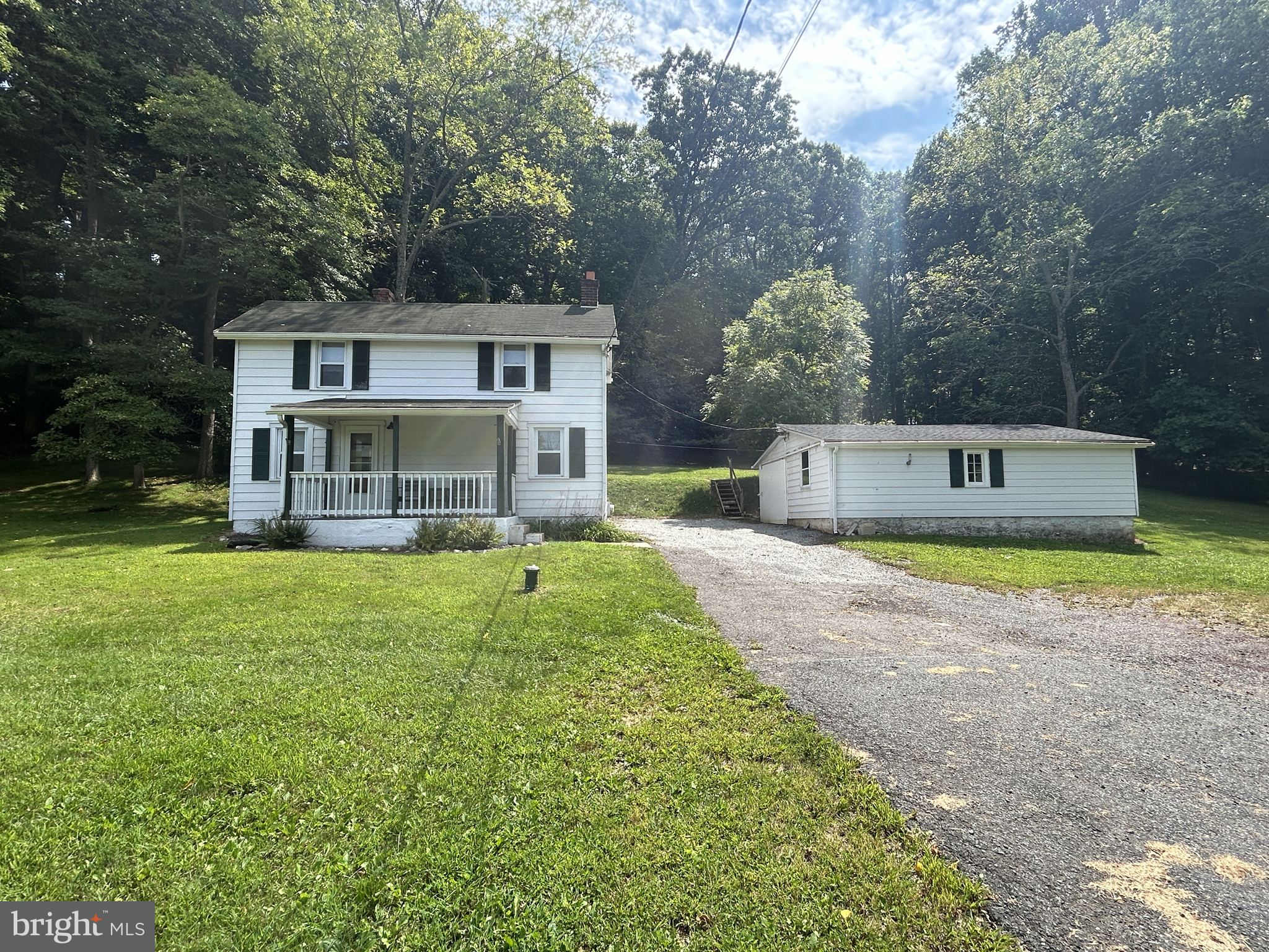 a view of a house with a backyard