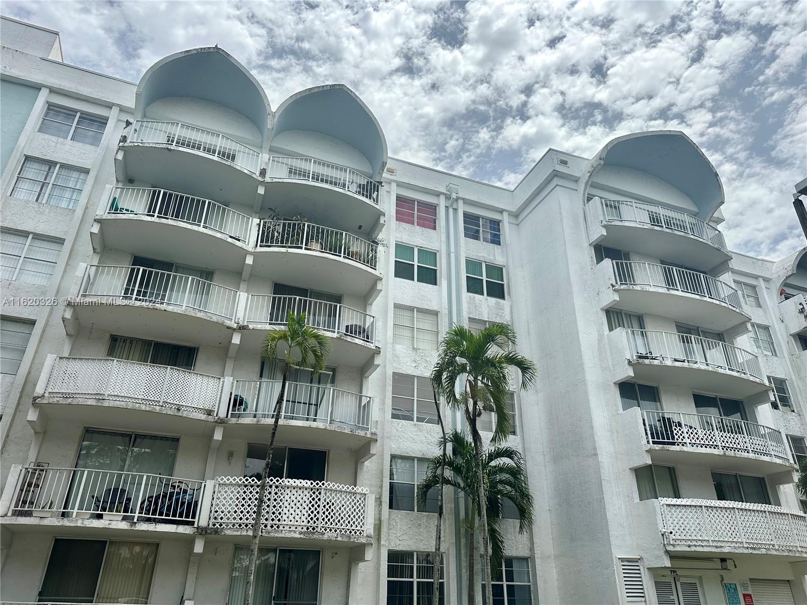 a front view of a building with balcony and entryway