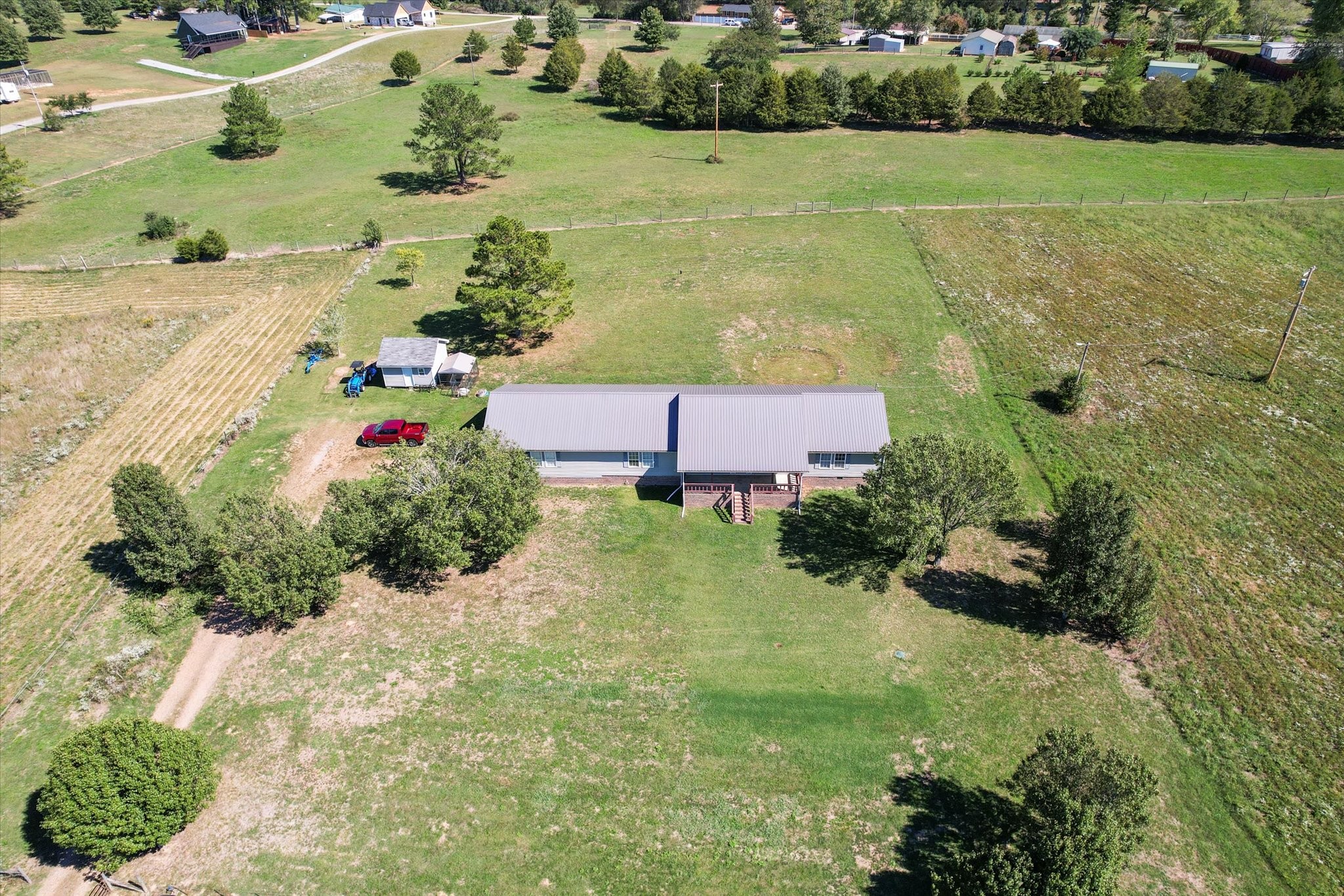 an aerial view of a house with a yard and lake view