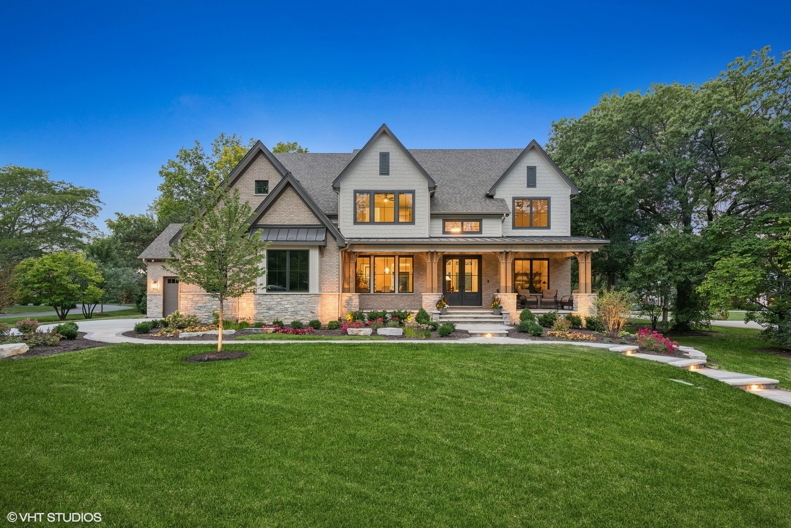 a front view of a house with a garden