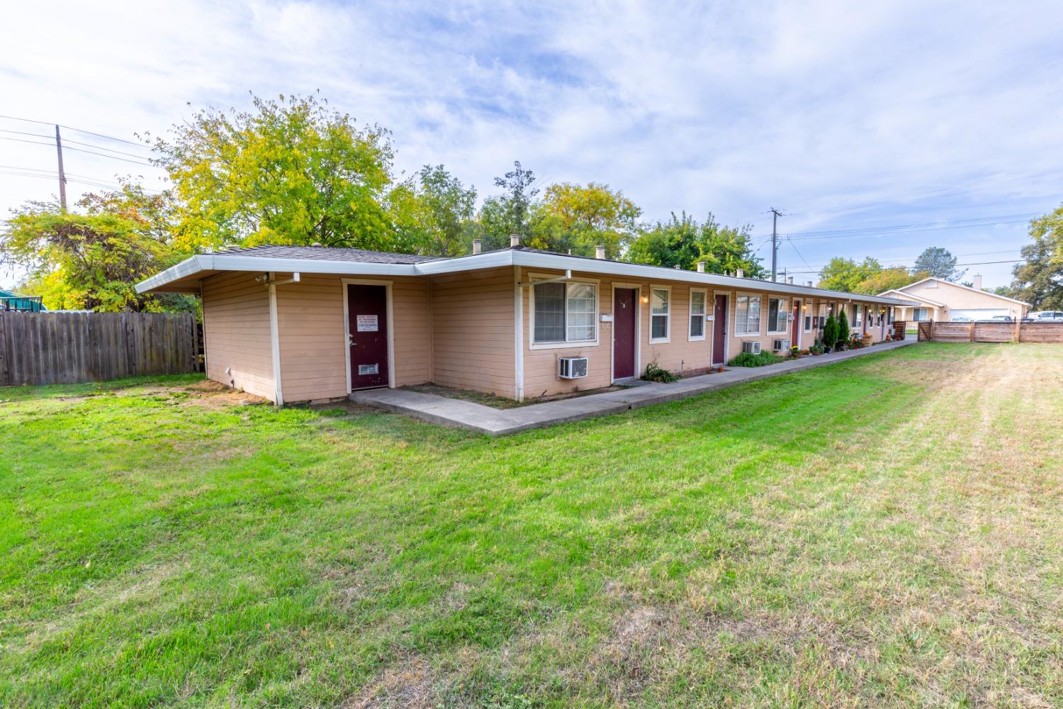 a view of a house with backyard and porch