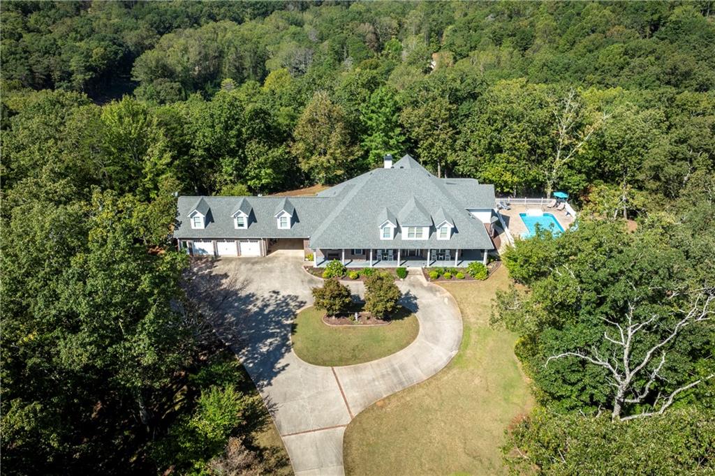 a aerial view of a house with swimming pool and garden