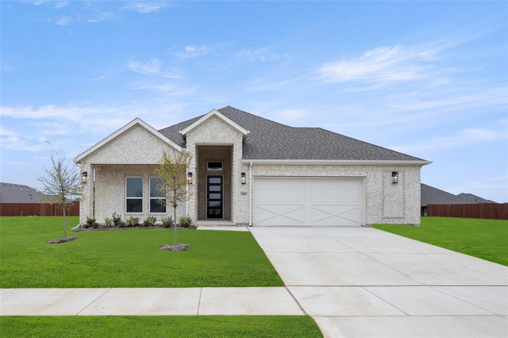 a front view of a house with a yard and garage