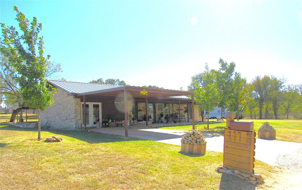 a swimming pool with outdoor seating and yard