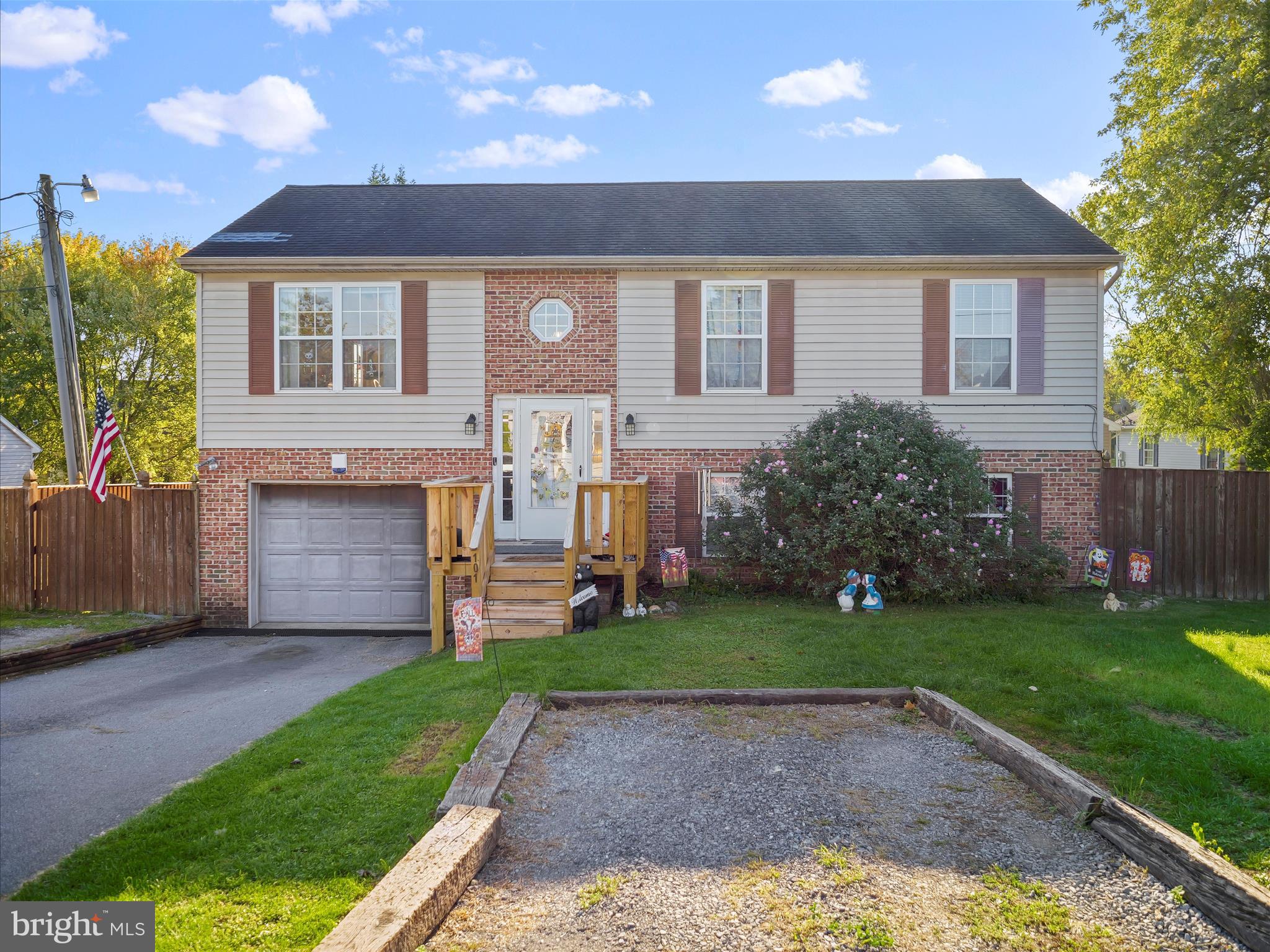 a front view of a house with a garden and yard